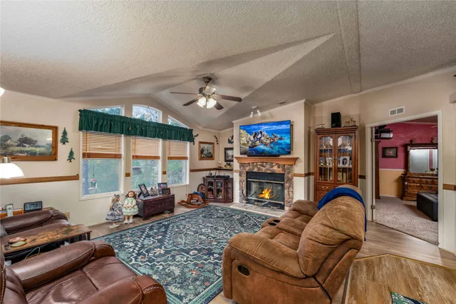 a living room with furniture fireplace and flat screen tv