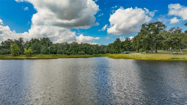 a view of a lake with houses in the background