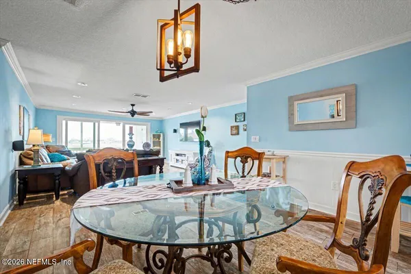 a view of a dining room with furniture and wooden floor