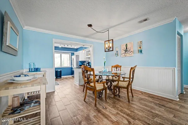 a view of a dining room with furniture and wooden floor