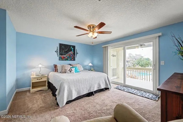 a bedroom with a large bed and a flat screen tv