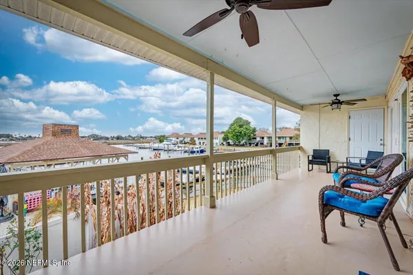 a view of a porch with chairs and couches