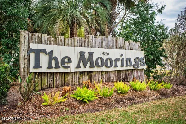 a street sign that is on a wooden wall