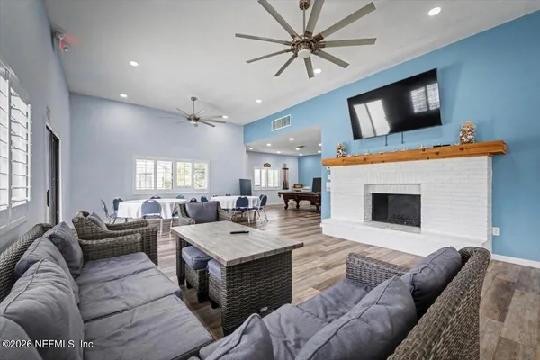 a room with wooden floor and pool table