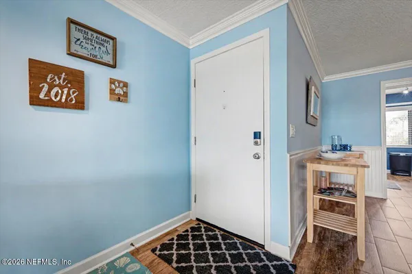 a living room with furniture large window and wooden floor