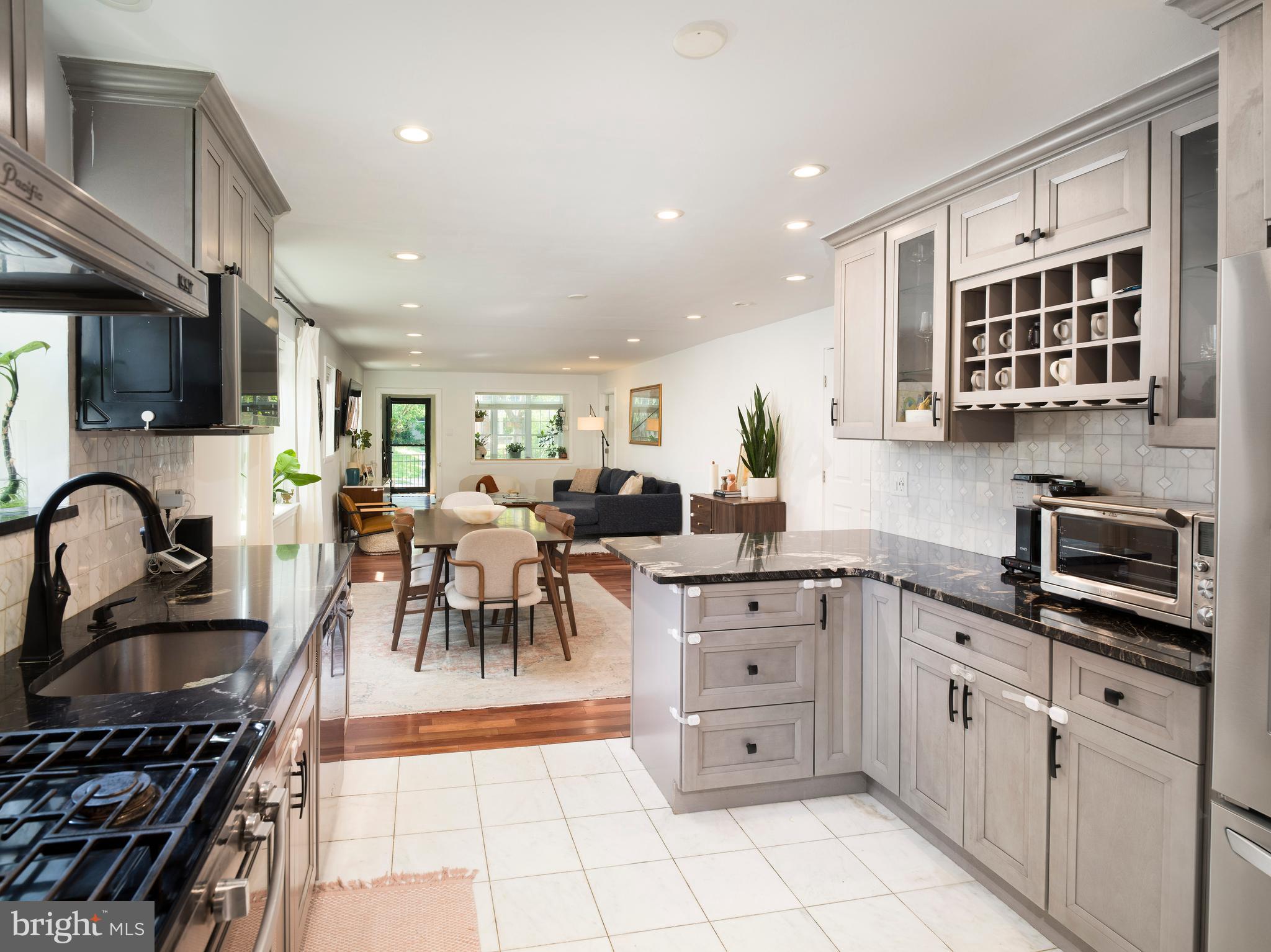 1455 Manoa Road Wynnewood, PA 19096 - Photo 11 of 27 a kitchen with stainless steel appliances granite countertop a stove a sink dishwasher a microwave oven with granite countertops and cabinets