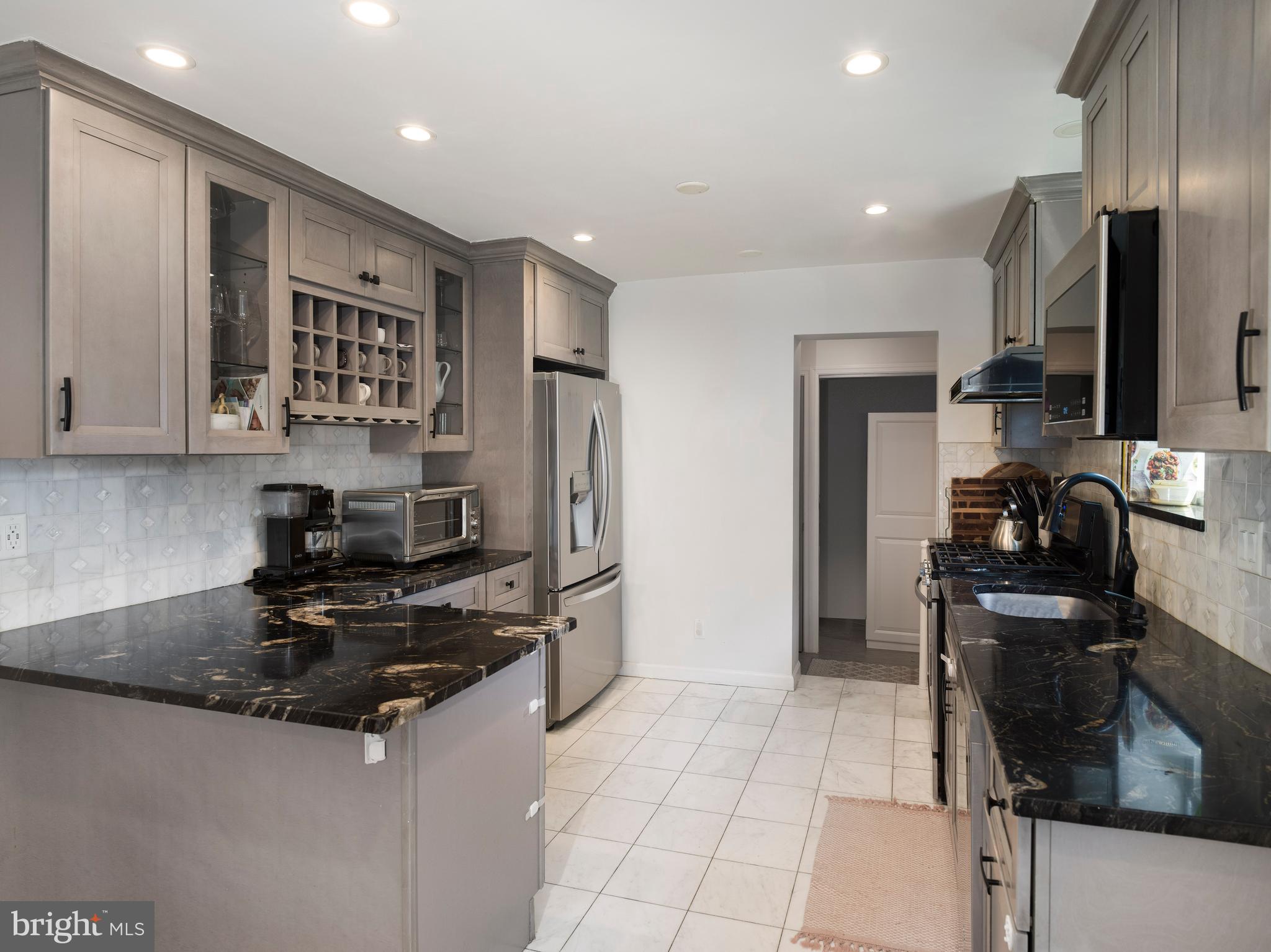 1455 Manoa Road Wynnewood, PA 19096 - Photo 12 of 27 a kitchen with stainless steel appliances granite countertop a refrigerator stove and sink