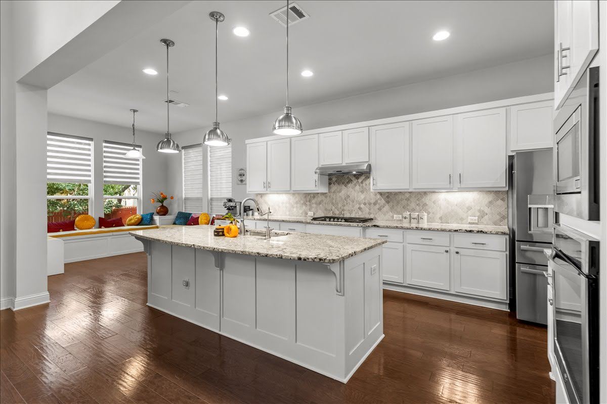 4108 Bison Bend, Unit FOR RENT Cedar Park, TX 78613 - Photo 8 of 36 Granite counters and rich hardwood floors define this well-appointed kitchen, complete with a generous island and abundant natural light.