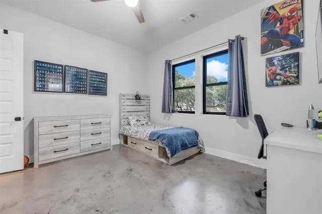 a bedroom with a bed and a window