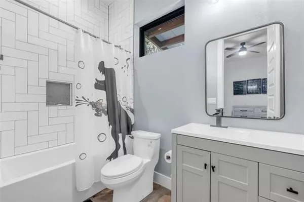 a bathroom with a sink toilet tub and shower