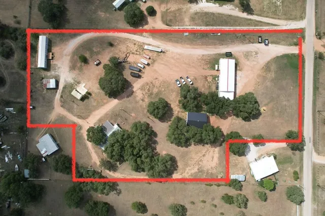 an aerial view of a house with outdoor space