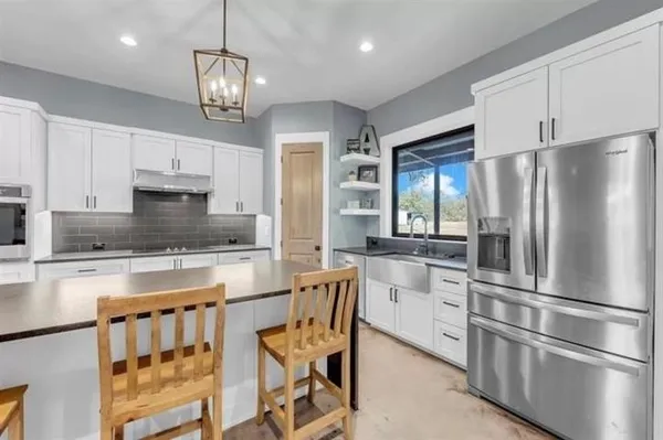 a kitchen with stainless steel appliances a refrigerator sink and cabinets