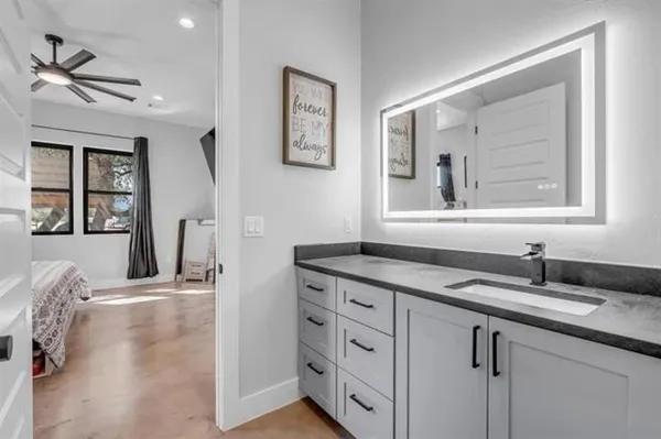 a bathroom with a granite countertop sink a mirror and a