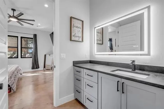 a bathroom with a granite countertop sink a mirror and a