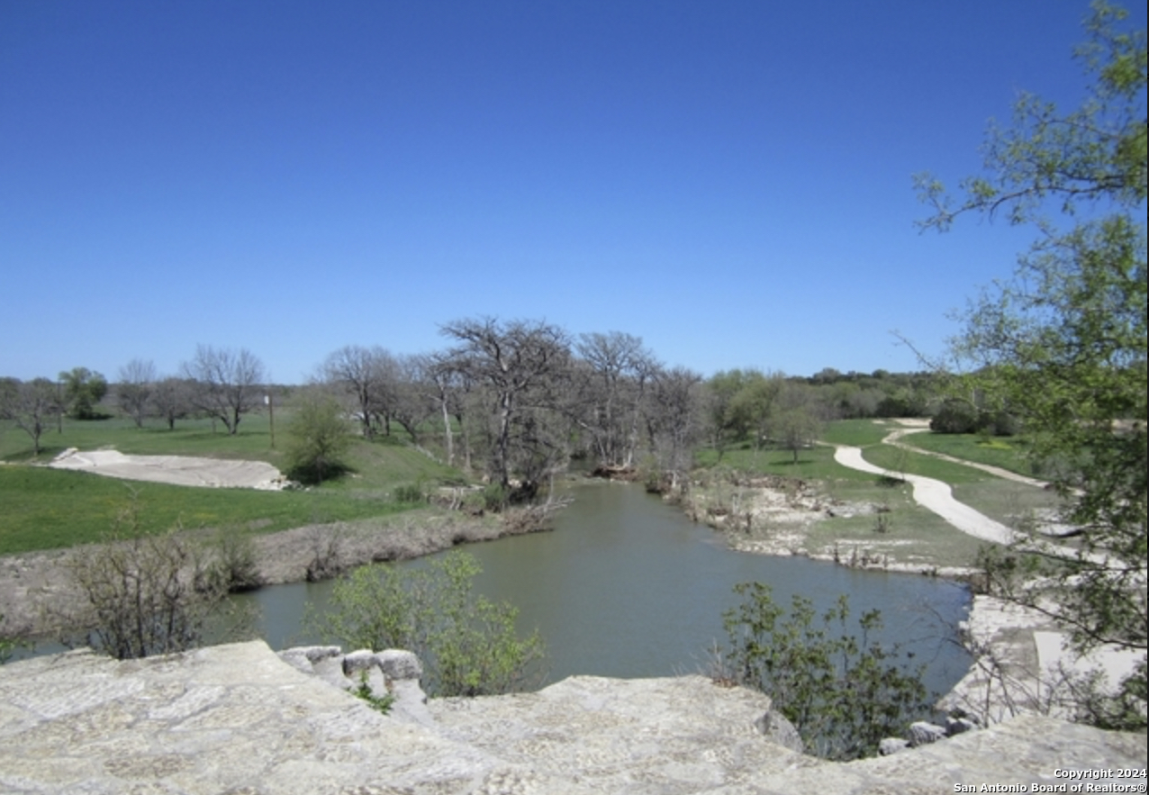 251 Highgate Drive Bandera, TX 78003 - Photo 5 of 7 a view of a lake with a yard