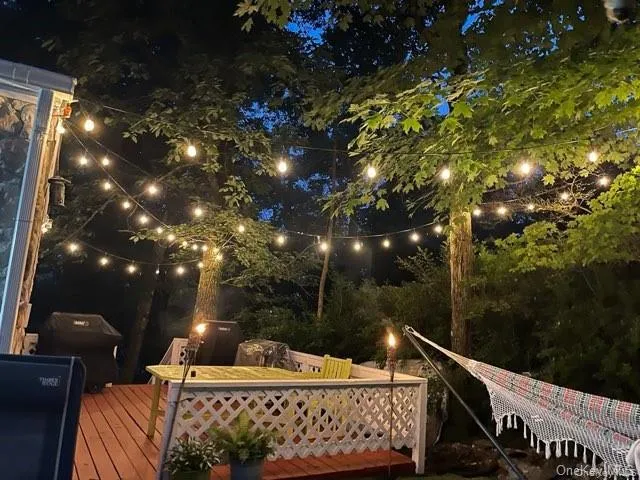 a living room with stainless steel appliances furniture a rug and a table