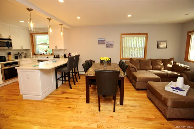 a living room with furniture a dining table and kitchen view