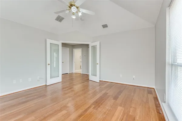 wooden floor in an empty room with a window