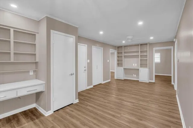 a view of empty room with wooden floor