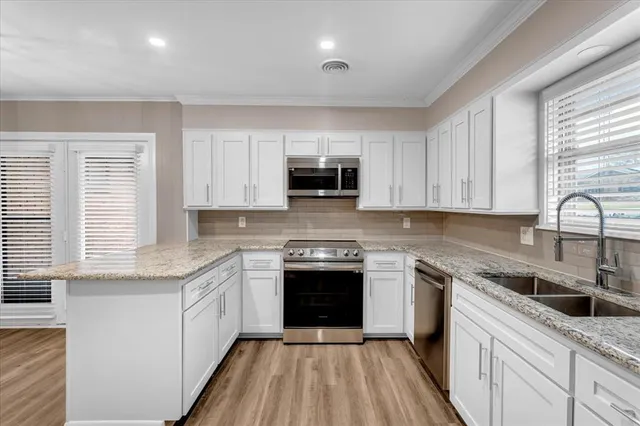 a kitchen with a sink stove and cabinets