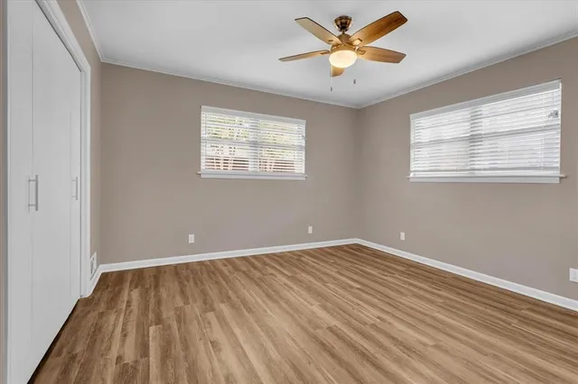 wooden floor in an empty room with a window