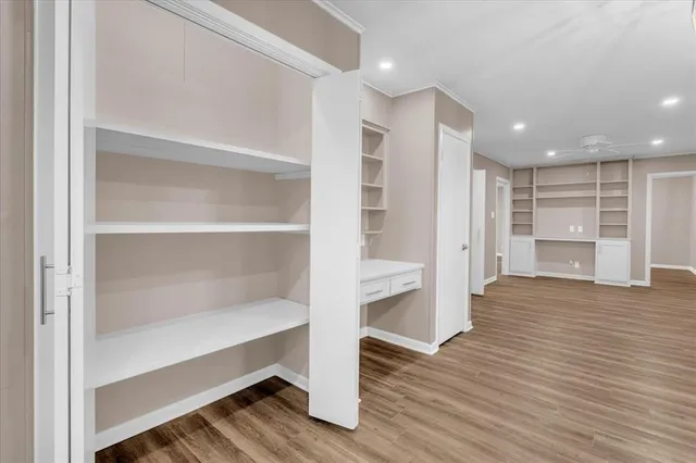a view of wooden floor and windows in a room