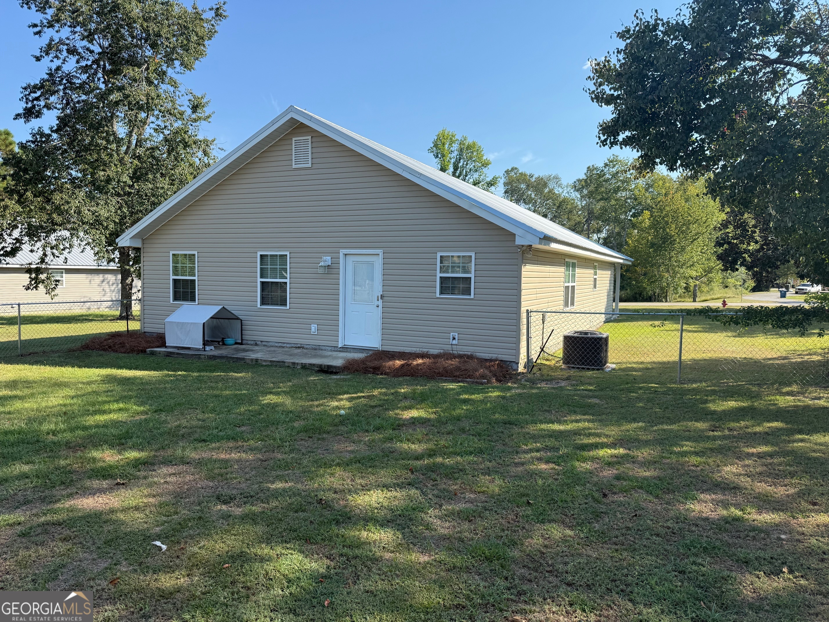1710 Aimwell Boulevard Vidalia, GA 30474 - Photo 20 of 21 a view of a house with a yard patio and swimming pool