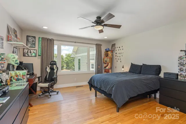 a living room with a bed furniture and a window