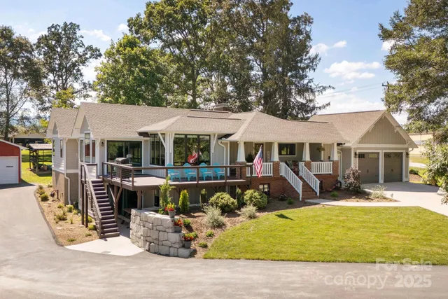 a front view of a house with swimming pool and furniture