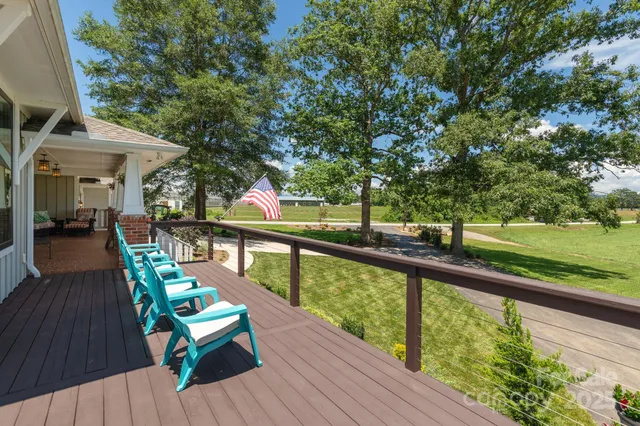 a view of a balcony with wooden floor and outdoor seating
