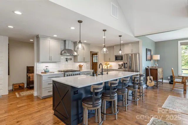 a large kitchen with a table and chairs