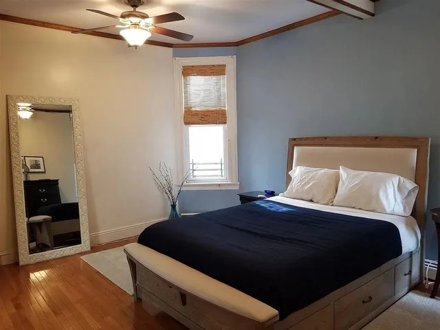 a bedroom with a bed and a chandelier