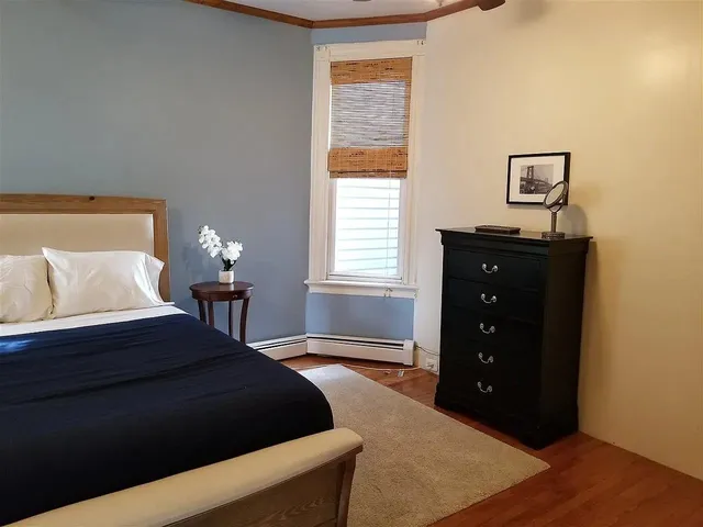a bedroom with a bed and window