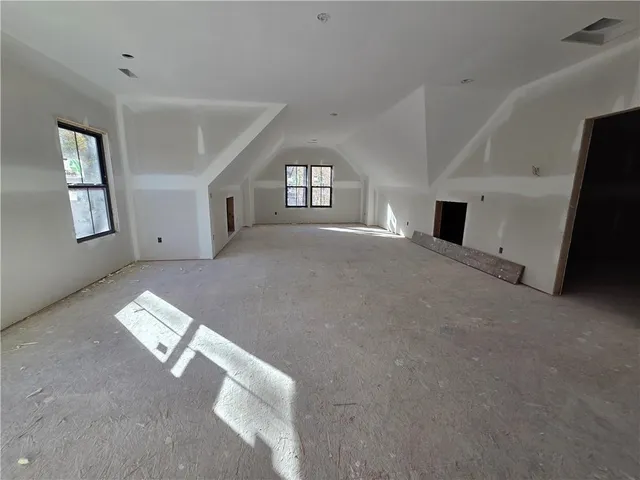 a view of livingroom with window and hallway with windows