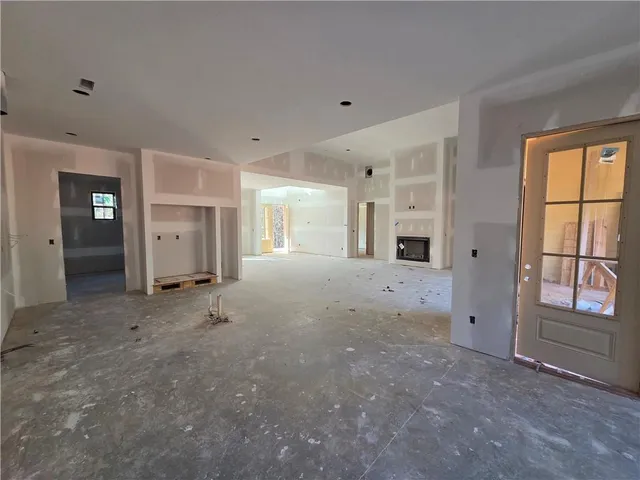 a view of a big room with windows and chandelier