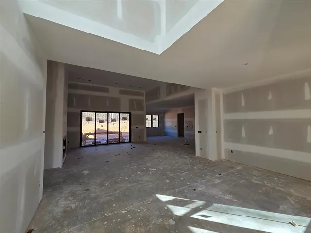 a view of an empty room with window and fireplace