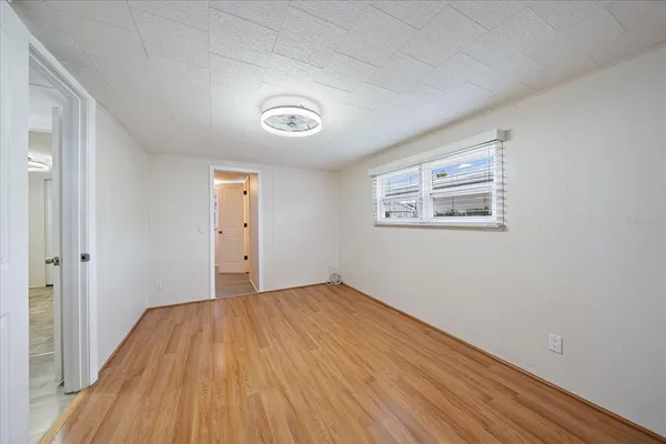a view of empty room with wooden floor
