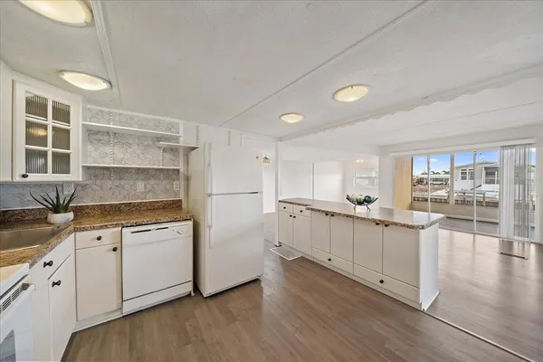 a kitchen with white cabinets sink and white appliances