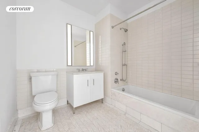 a bathroom with a toilet sink and shower