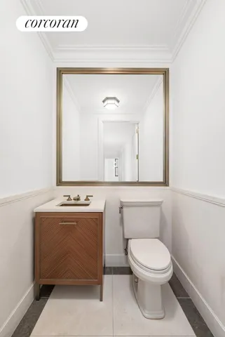 a bathroom with a toilet a sink and mirror