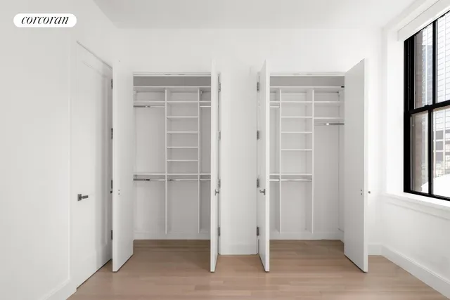 a view of an empty room with closet area