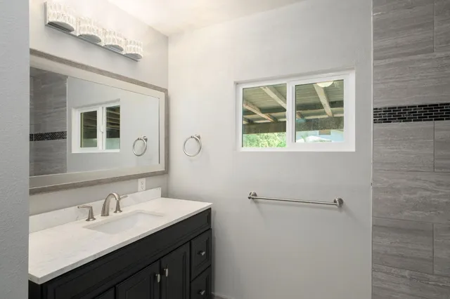 a bathroom with a double vanity sink and a mirror