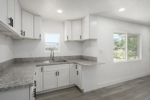 a kitchen with a sink stove and cabinets