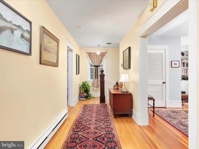 a view of a dining room and hall with furniture