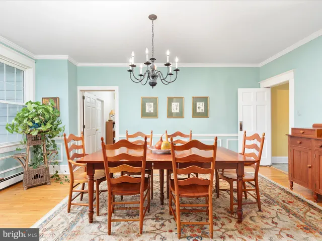 a view of a dining room with furniture wooden floor and chandelier