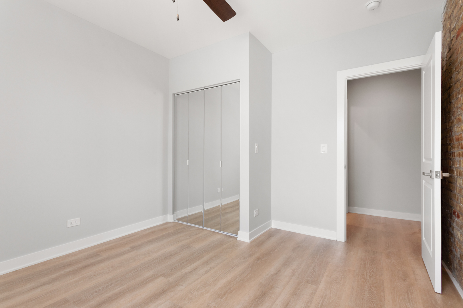 7383 North Damen Avenue, Unit 3E Chicago, IL 60645 - Photo 11 of 14 a view of an empty room with wooden floor
