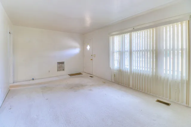 a kitchen with granite countertop a sink stove and cabinets