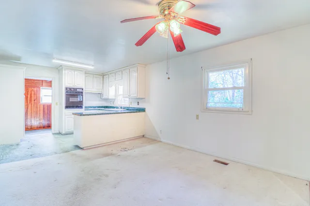 a kitchen with granite countertop white cabinets and white appliances