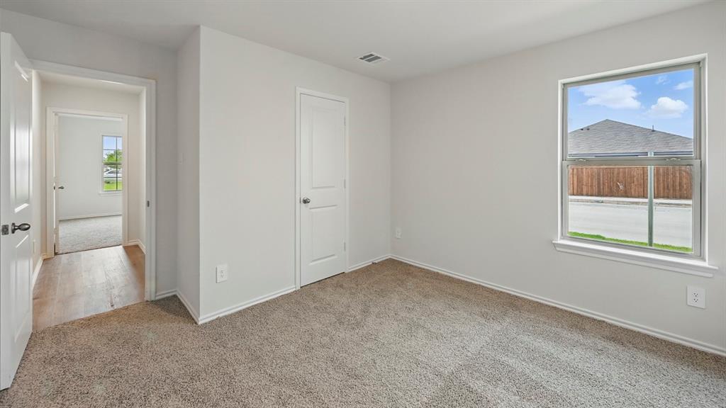 1908 Freeman Street Tyler, TX 75704 - Photo 25 of 30 Bedroom featuring neutral-toned carpeting, a window with white trim, and light-colored walls