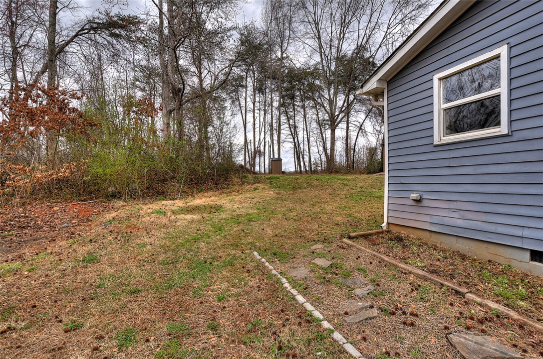 325 Rock Quarry Road Travelers Rest, SC 29690 - Photo 29 of 37 This property features a spacious yard with mature trees, offering a serene outdoor environment.